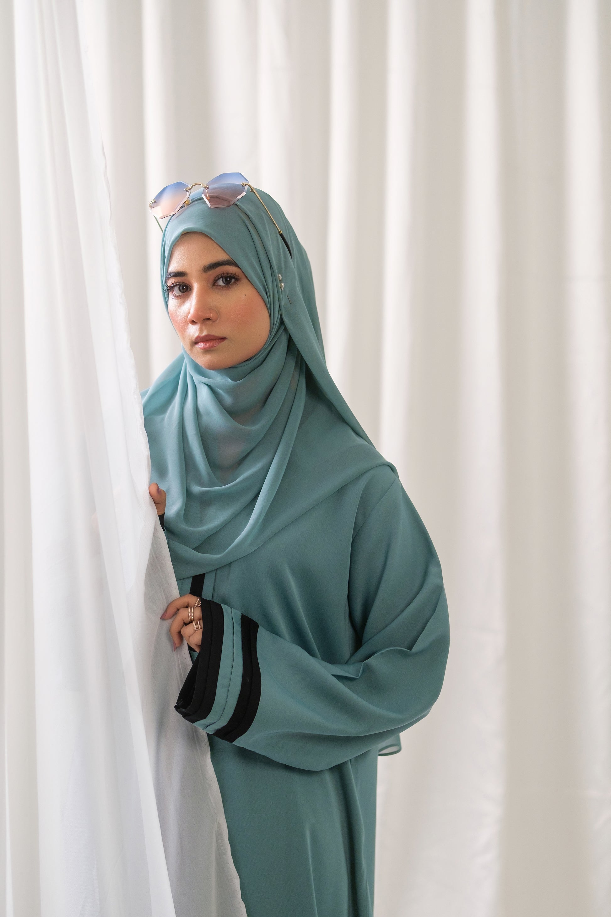 Dhaagey Aqua Serene Abaya in Imported Nidha Fabric with Black Contrast Trim, left view