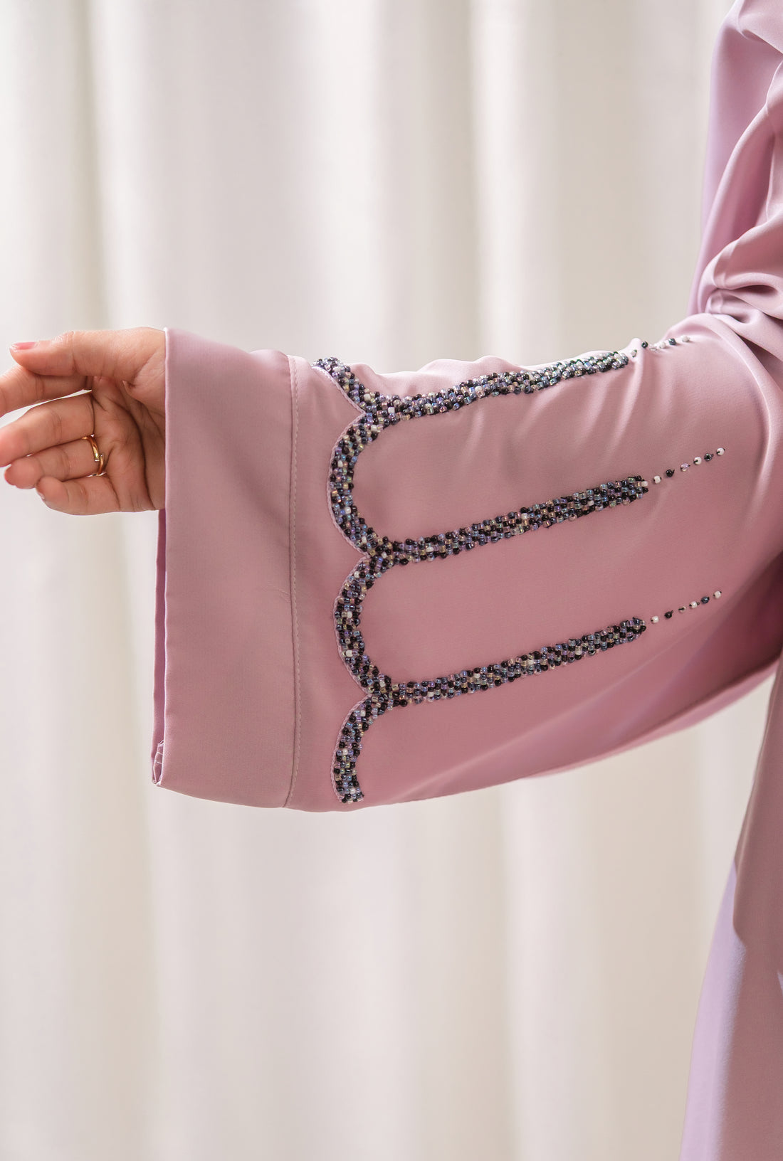 Dhaagey Azure Arch Front-Open Abaya in Nude Pink Nidha, showing dark scalloped beadwork on the hem and sleeves.