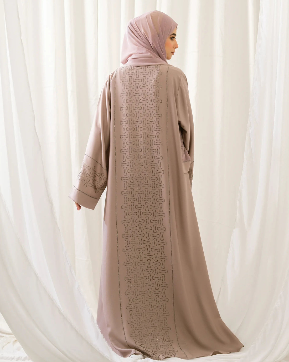 Full front view of the Dhaagey Crystal Lattice Abaya in warm beige Imported Nidha. The front-open design features delicate crystal trim along the neckline edge, with wide, shimmering geometric crystal lattice bands clearly visible on the sleeves.