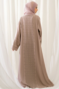 Back view of the Dhaagey Crystal Lattice Abaya in beige showing the dramatic full-length vertical crystal lattice panel down the center.