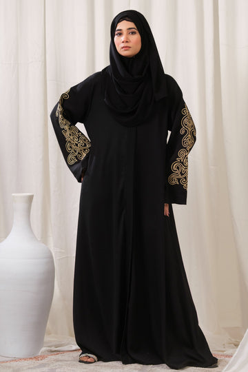 Dhaagey Golden Heirloom Front-Open Abaya in black Zoom Nidha, full length, showing gold thread embroidery on the sleeves and matching black Chiffon hijab.