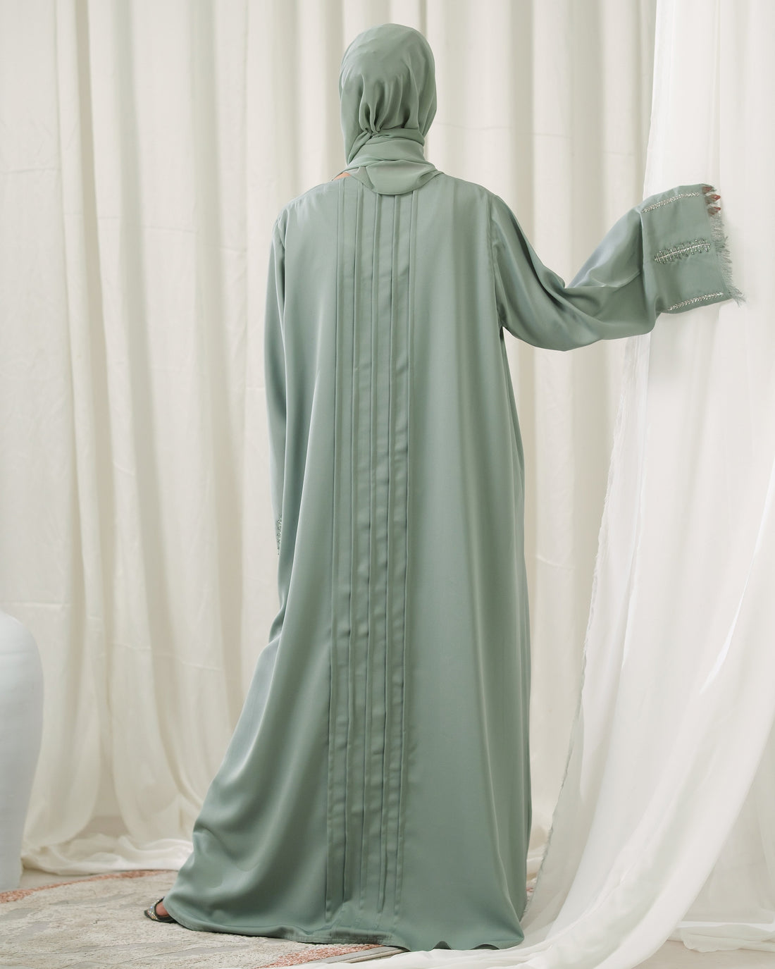Dhaagey Mint Pleat Dusty Mint Front-Open Abaya in Imported Nidha, showing embroidered cuffs and matching Chiffon hijab.