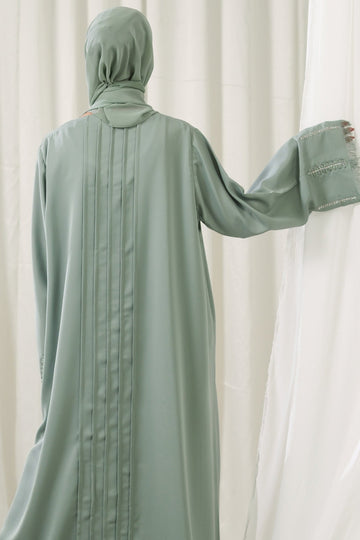 Dhaagey Mint Pleat Dusty Mint Front-Open Abaya in Imported Nidha, showing embroidered cuffs and matching Chiffon hijab back.