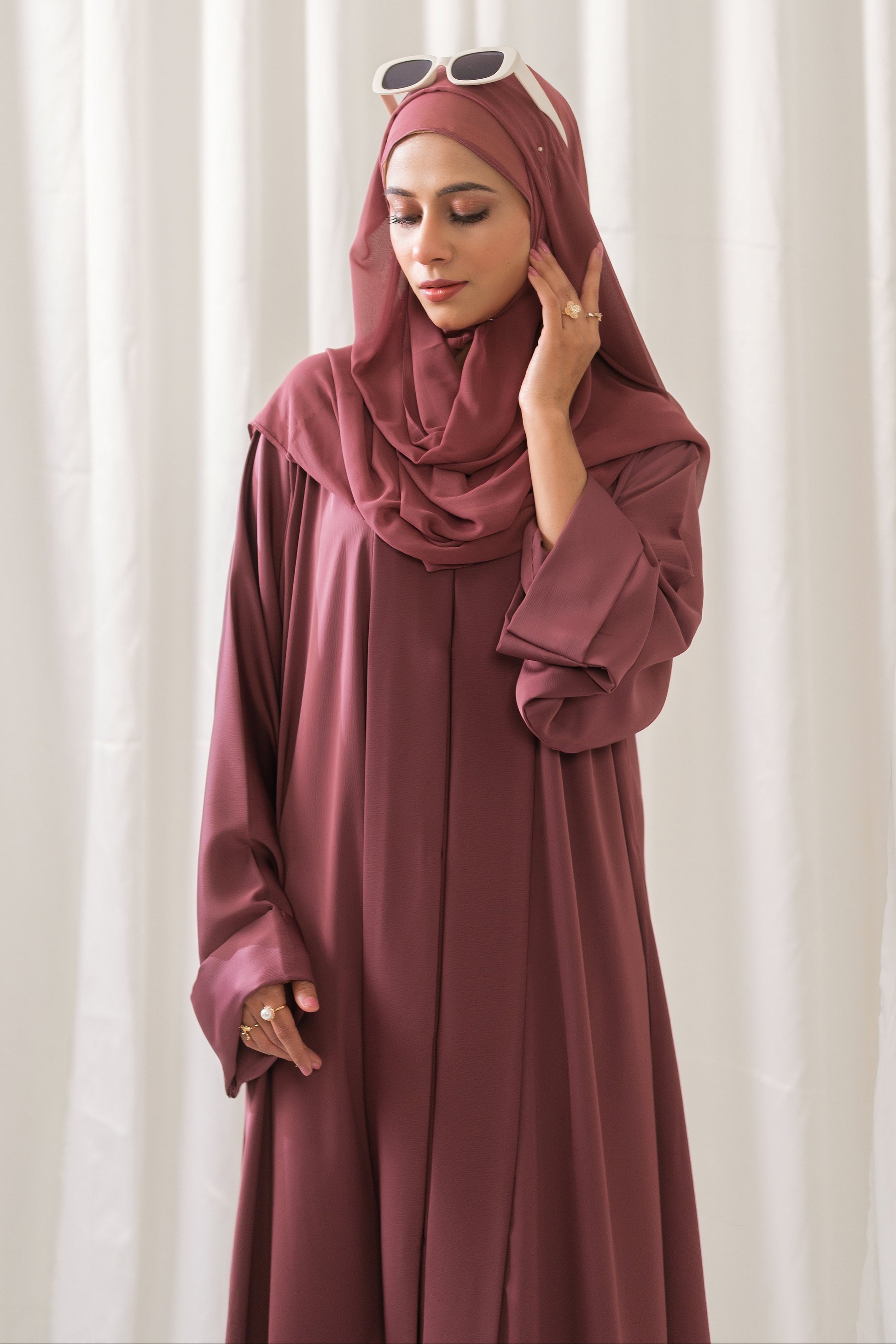 Dhaagey Rosalie Pleat Front-Open Abaya in Dusty Rose Romantic Nidha, showing sharp vertical pleats on the front and cuffs, and matching Chiffon hijab.