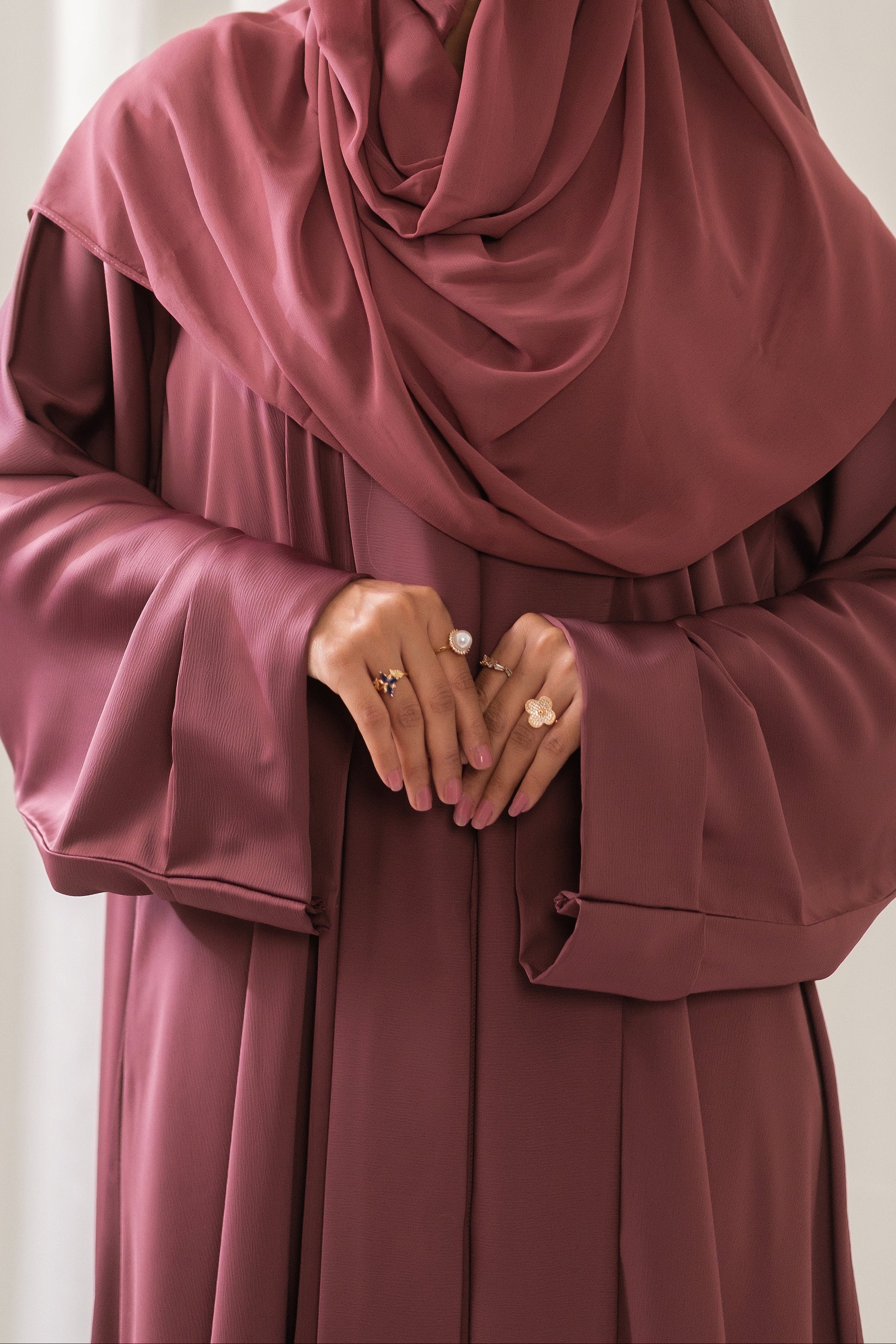Dhaagey Rosalie Pleat Front-Open Abaya in Dusty Rose Romantic Nidha, showing sharp vertical pleats on the front and cuffs, and matching Chiffon hijab. close up