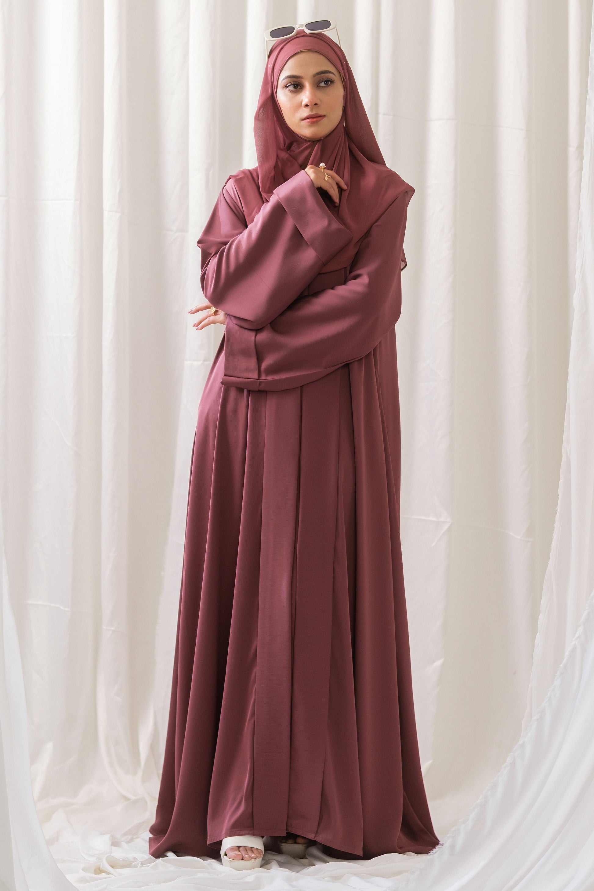 Dhaagey Rosalie Pleat Front-Open Abaya in Dusty Rose Romantic Nidha, showing sharp vertical pleats on the front and cuffs, and matching Chiffon hijab.