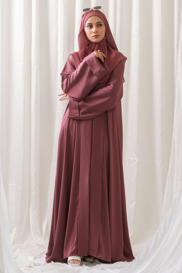 Dhaagey Rosalie Pleat Front-Open Abaya in Dusty Rose Romantic Nidha, showing sharp vertical pleats on the front and cuffs, and matching Chiffon hijab.