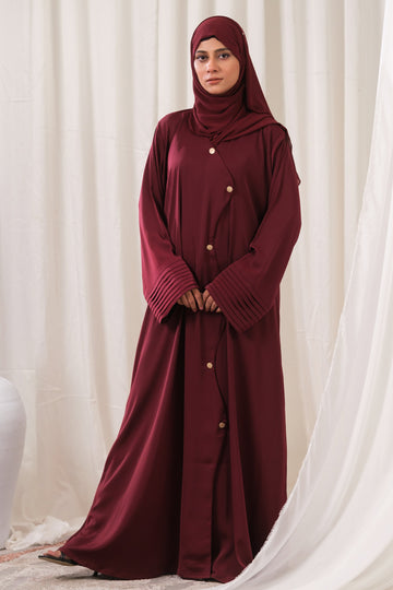 Dhaagey Regalia Front-Open Abaya in Burgundy, showing the structured fit, gold buttons, and micro-pleated bell cuffs.