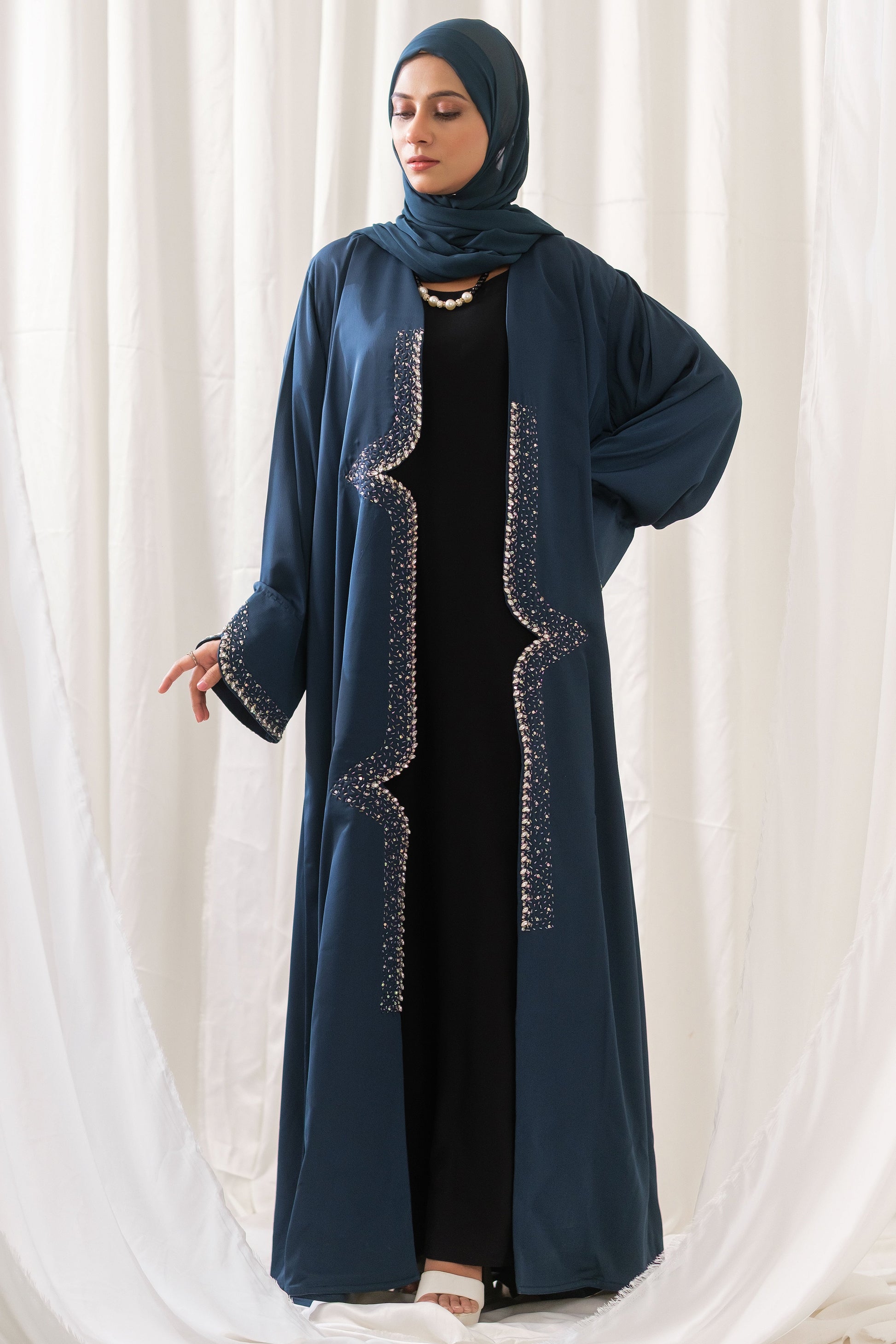 Dhaagey Lumina Front-Open Abaya in Deep Teal Nidha, showing vertical crystal beaded trail down the front panels and the heavily beaded cuffs.