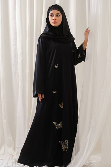 Dhaagey Monarch Front-Open Abaya in Black Nidha, showing vertical trail of beaded butterfly motifs down the front and up the length of one sleeve.