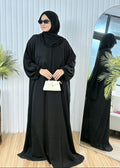 Classic black travel butterfly abaya featuring wudu-friendly elastic cuffs and white mini purse.