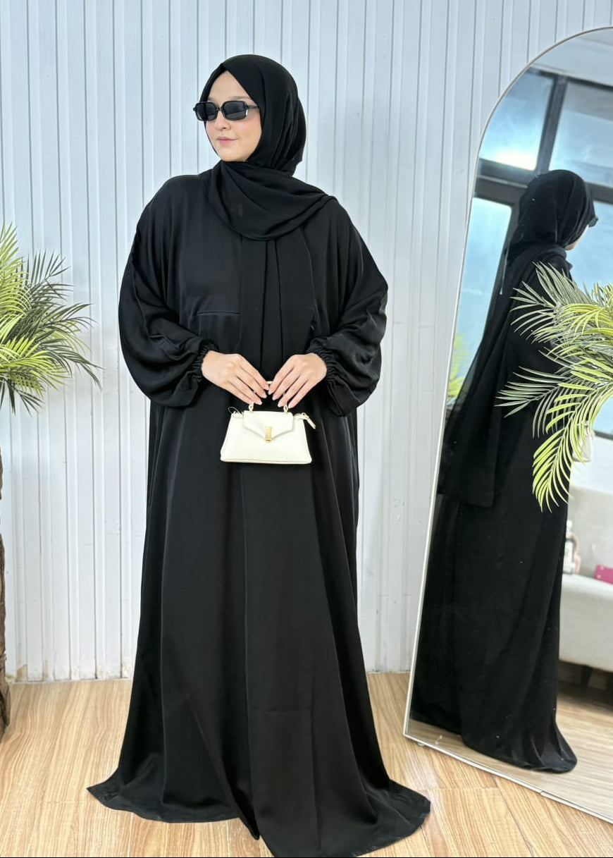 Classic black travel butterfly abaya featuring wudu-friendly elastic cuffs and white mini purse.